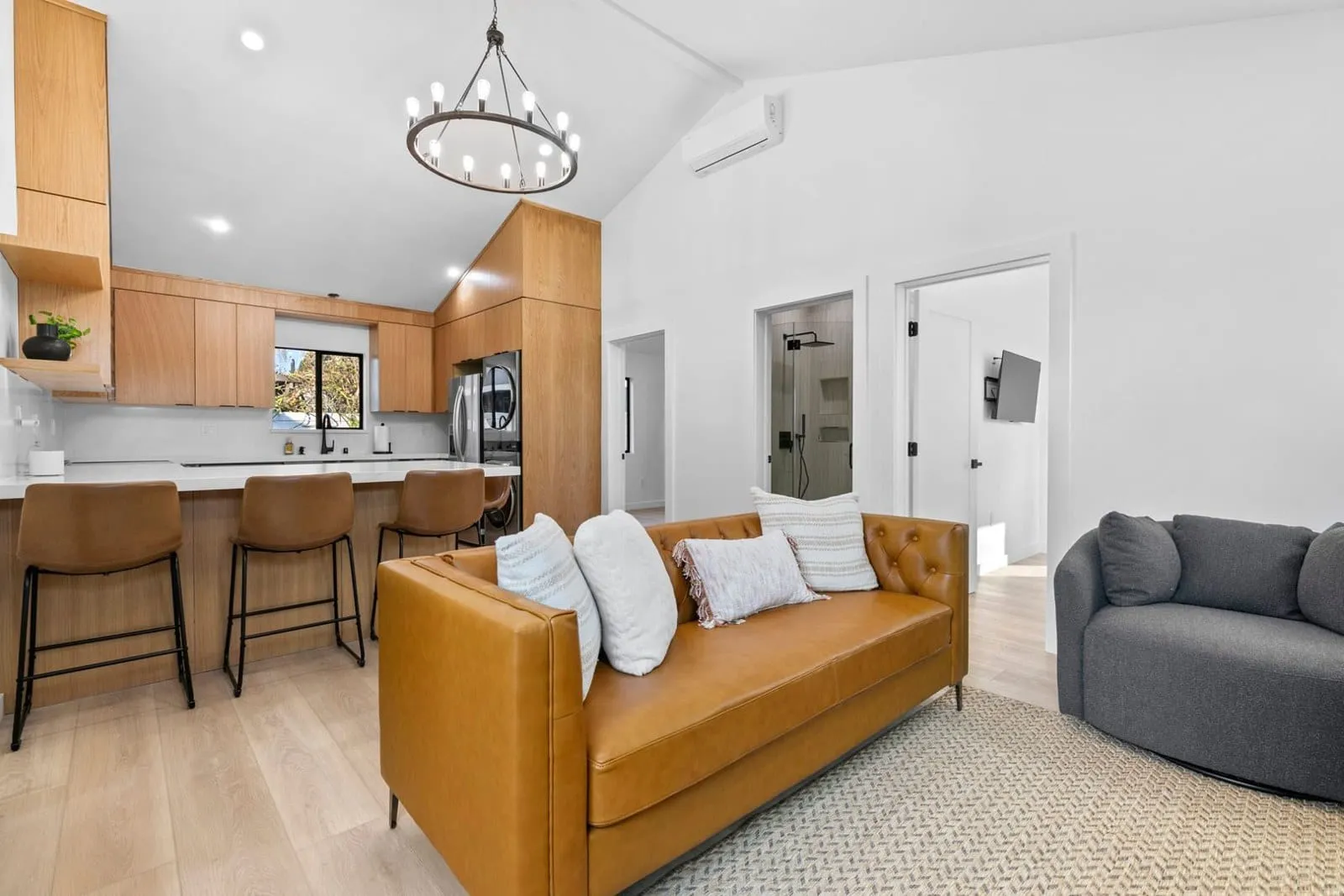 Interior of a completed ArcLine Builders home with a vaulted ceiling and open kitchen